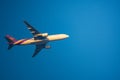 Closeup Thai Airways International Airline plane. Boeing 777-2D7ER taking off from Suvarnabhumi Airport with clear blue sky.