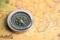 Bangkok, Thailand - January 20, 2022 Compass for navigation on vintage old antique world map background to travel, geography, Royalty Free Stock Photo