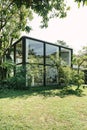 BANGKOK, THAILAND - JANUARY 22, 2017: A glass house near green t Royalty Free Stock Photo