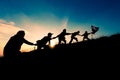 Silhouette of people helping each other hand by hand Royalty Free Stock Photo