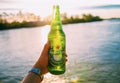 BANGKOK0, THAILAND - JANUARY 2 , 2019: handed bottle of cold Heineken beer on dark brown bacony with water drop and blurred