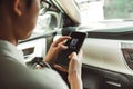 BANGKOK, THAILAND - JANUARY 22: A man using Uber app on smartphone on January 22, 2017 in Bangkok. Royalty Free Stock Photo