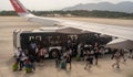 Bangkok, Thailand, 24 January 2024: Passengers exiting shuttle bus, heading towards airplane ramp for boarding. Airport scene with Royalty Free Stock Photo