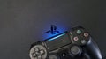 Sony PlayStation 4 Slim PS4 with DualShock 4 controller shining blue LED on logo, Home video game console Royalty Free Stock Photo