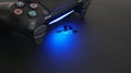 Sony PlayStation 4 Slim PS4 with DualShock 4 controller shining blue LED on logo, Home video game console Royalty Free Stock Photo