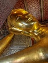 Bangkok, Thailand - January 1st 2020: Famous Reclining Buddha statue gold face. Sleeping Buddha. Wat Pho, Bangkok, Thailand. Royalty Free Stock Photo