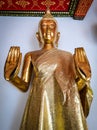 Standing golden Buddha statue in Wat Pho buddhist temple, Bangkok, Thailand.