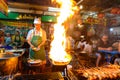 Bangkok, Thailand - January 26, 2019 : Street food chef cooking with fire at Yaowarat road in Bangkok Royalty Free Stock Photo