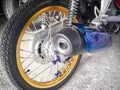 BANGKOK, THAILAND - JANUARY 02, 2018: Thoroughly cleaned and detailed light motorcycle drive wheel and exhaust muffler with