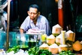 Bangkok, Thailand, January 12 2018: Trader cutting the coconut for coconut water in China Town market of Bangkok