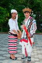 Kachin or Jingpo people in traditional clothes wear traditional wicker hats with wild boar tusks. A woman wears a white headdress. Royalty Free Stock Photo