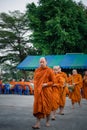 Thai monk ask for alms for buddhist to make merit Royalty Free Stock Photo