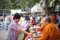 Thai monk ask for alms for buddhist to make merit Royalty Free Stock Photo