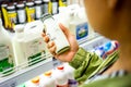 BANGKOK THAILAND - January 12, 2020: Woman`s hand buying milk in the supermarket. Woman choosing milk in dairy product department Royalty Free Stock Photo