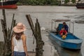 Young woman in casual clothes standing on an old wooden pier Royalty Free Stock Photo