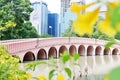 Bangkok,Thailand - July 27,2023 : A beautiful red bridge in Jatujak public park with a high building around the area Royalty Free Stock Photo