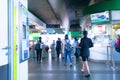 BTS Skytrain in the morning is very bright. Motion blur of People walking in and out of the station, Blue white tones.