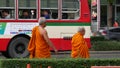 BANGKOK, THAILAND - 13 JULY, 2019: Buddhist holy Monk in traditional orange robe on the steet. Monks yellow religious clothes