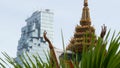 BANGKOK, THAILAND - 13 JULY, 2019: Conceptual contrast of oriental old traditional ancient temple and modern new futuristic