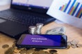 BANGKOK, THAILAND, JULY 23, 2019: Facebook and Libra text display on smartphone with gold silver coin, Dollar bill and laptop Royalty Free Stock Photo