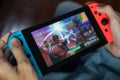 Gamer playing Fortnite game on Nintendo Switch. Royalty Free Stock Photo