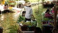 BANGKOK, THAILAND - 13 JULY 2019: Lat Mayom floating market. Traditional classic khlong river canal, local women farmers, long-