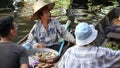 BANGKOK, THAILAND, 13 JULY 2019 Lat Mayom floating market. Traditional classic khlong river canal, local women in long-tail boats