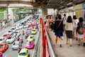 Bangkok, Thailand - July 07 2019: Cars cause traffic jams at Rama I Road. BTS at Siam Station. People walk on skywalk