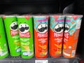 Many flavors of Pringles potato chip on shelf on 7-11