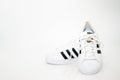 Bangkok,Thailand,July 2,2021-original adidas sneakers shoes with shoelace on white floor front view soft focus with copy space