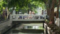 BANGKOK, THAILAND - 11 JULY, 2019: Street city life near river canal in siam. Traditional khlong with bridge near local market.