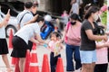 Bangkok Thailand-16 July 20: Teacher pumped the alcohol to the students who were walking into the school with the mother.