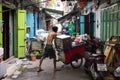 Man wheeling a cart in a backstreet, Chinatown, Bangkok, Thailand