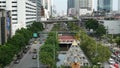 BANGKOK, THAILAND - 13 JULY, 2019: Traffic on modern city street. Contemporary train riding on railroad bridge over road with cars