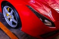 Close-up of Headlights, Wheel, and Rim of Red metallic Ferrari car Royalty Free Stock Photo