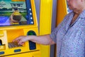 Bangkok, Thailand - June 20, 2018 : Asian senior or elderly old lady woman entering press button number code on machine