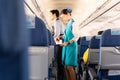 BANGKOK, THAILAND - June 27, 2019 - Bangkok Airways flight attendant serve food to passengers on board.