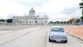 Bangkok, Thailand - June 30, 2020: Blue classic Mini Austin parked on street with ancient castle and sky background in center of B Royalty Free Stock Photo