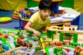 BANGKOK, THAILAND - JUNE 18: A boy plays with wooden train set i