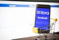 Libra coin blockchain concept with smartphone on shopping cart / New project libra a cryptocurrency launched by Facebook looks to