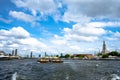 BANGKOK, THAILAND - June 12, 2019: The local boat cruised along Chao phraya river. A newly white paint of Wat Arun, famous Royalty Free Stock Photo