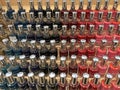 Lot of colorful bottles of nail polishes on shelf