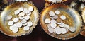 Many coins on brass tray with pedestal for praying monk at Thai temple. Faith of Buddhism and Asian people