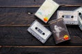 Bangkok, Thailand - June,23 2021 : 90`s cassette tapes of The Beatles, John Lennon on a black wooden floor