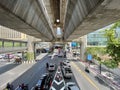 Skywalk above Rama I Road with cars and scooters mostly ride in shade during off-peak hours