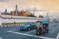 Bangkok,Thailand - June ,2019 : Tuk tuk on the background of Bangkok`s Grand Palace Complex and Wat Phra Kaew Temple of the Royalty Free Stock Photo