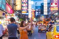 Bangkok, Thailand: two admiring travelers in Yaowarat Road, Chinatown at night