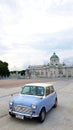 Two tone of blue and white Classic Mini Austin parked on street with ancient castle and sky background Royalty Free Stock Photo