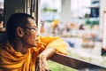 BANGKOK, THAILAND - JUNE 16: An unidentified monk looking out th