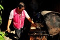 Bangkok, Thailand: Man Grilling Chicken Royalty Free Stock Photo